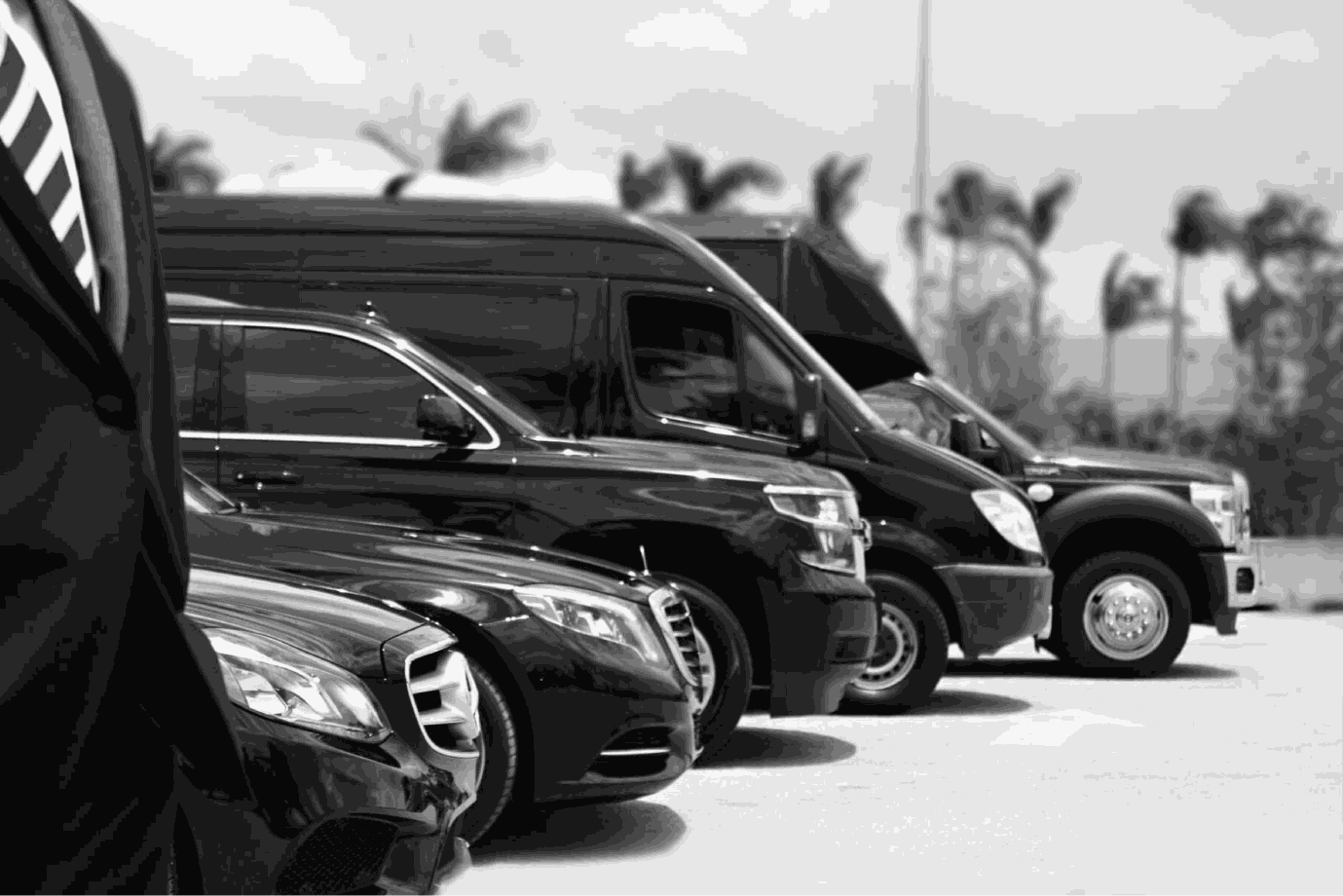 Black Grandeur chauffeur with a luxury vehicle